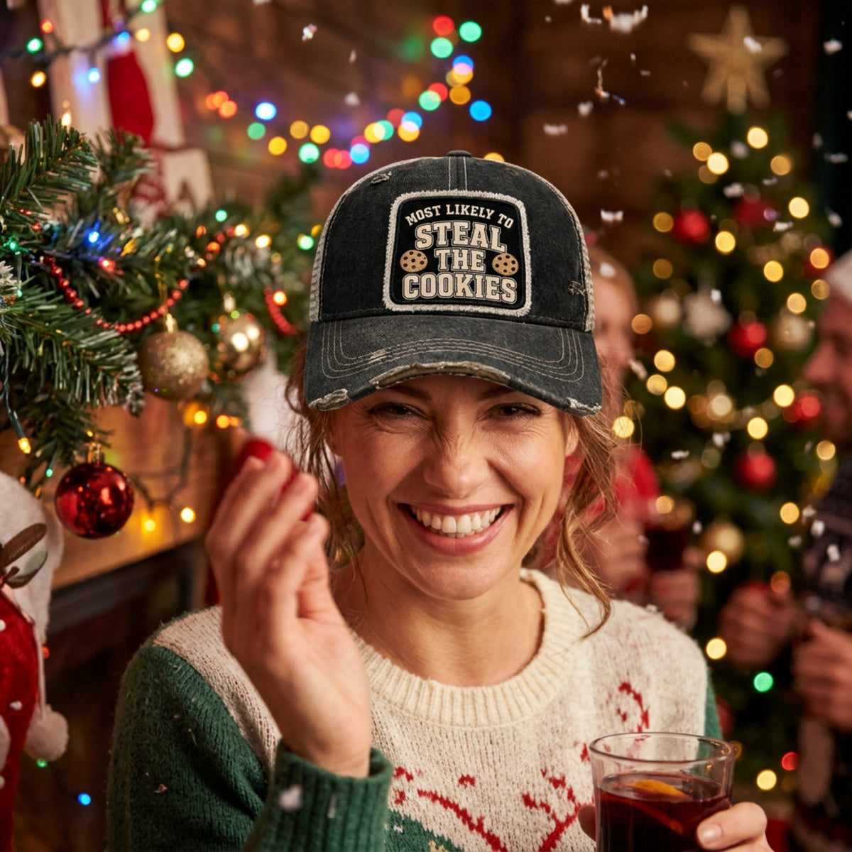 Woman at a Christmas party wearing the black MOST LIKELY TO STEAL THE COOKIES trucker hat
